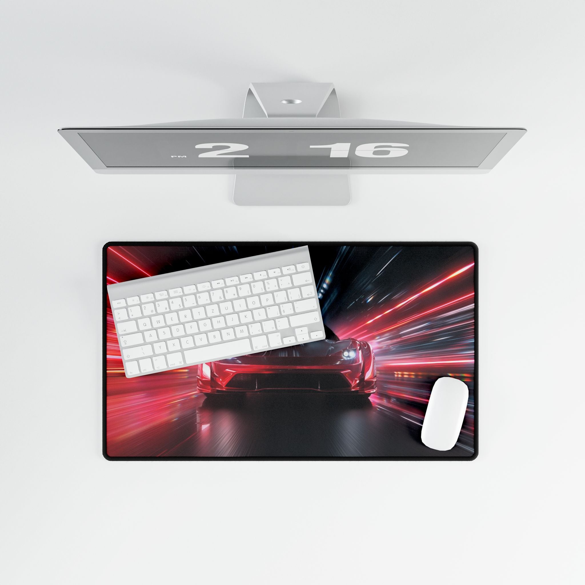Computer monitor with a large mouse pad featuring a car and keyboard design on a white background