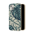 A slightly angled, full-length view of a beige, speckled iPhone case with a teal and blue monstera leaf pattern. The case is open and shown from the side, revealing its smooth brown interior and the dual camera cutout at the top.