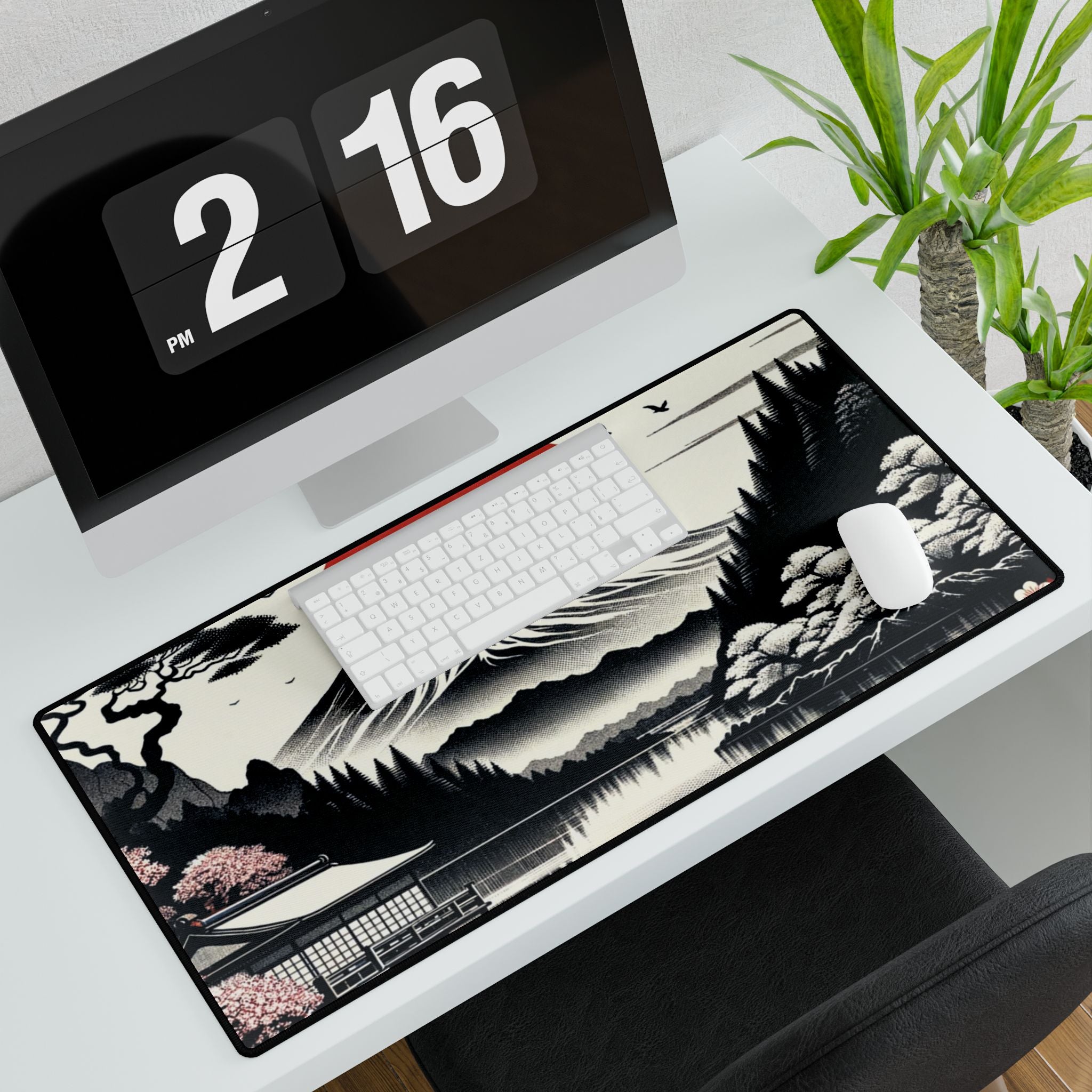 Desk setup with a large decorative mouse pad featuring a landscape design, keyboard, and computer monitor.