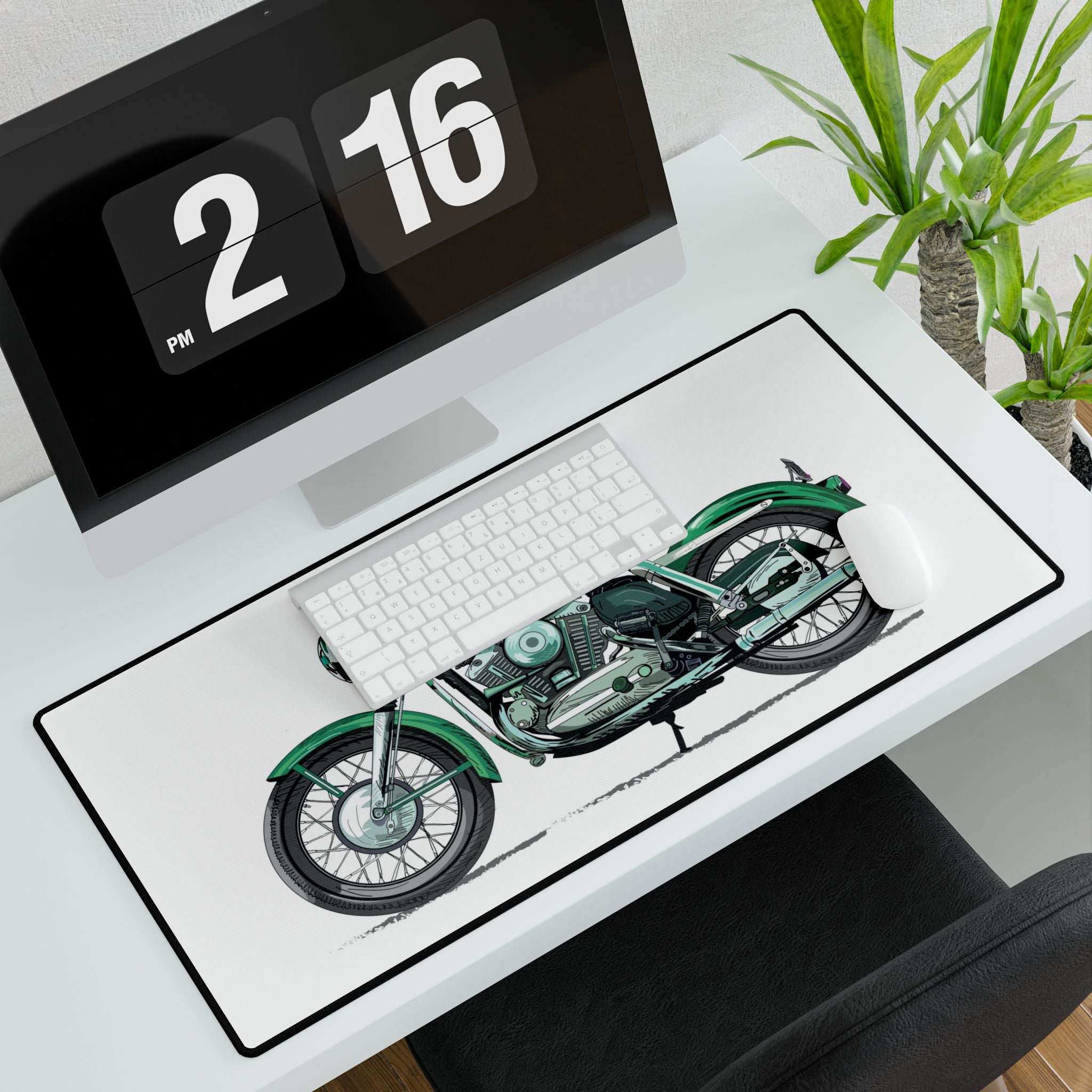 Desk setup with a motorcycle design mouse pad, keyboard, and digital clock.