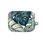 AirPods case with a tropical leaf pattern, featuring large, stylized green and cream monstera leaves. The case is closed, showcasing the detailed pattern from the front view.