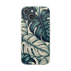 A full, straight-on view of an iPhone in a beige, speckled case with a teal and blue monstera leaf pattern. The case covers the entire back of the phone, and the dual camera lens cutout is visible in the top left corner.