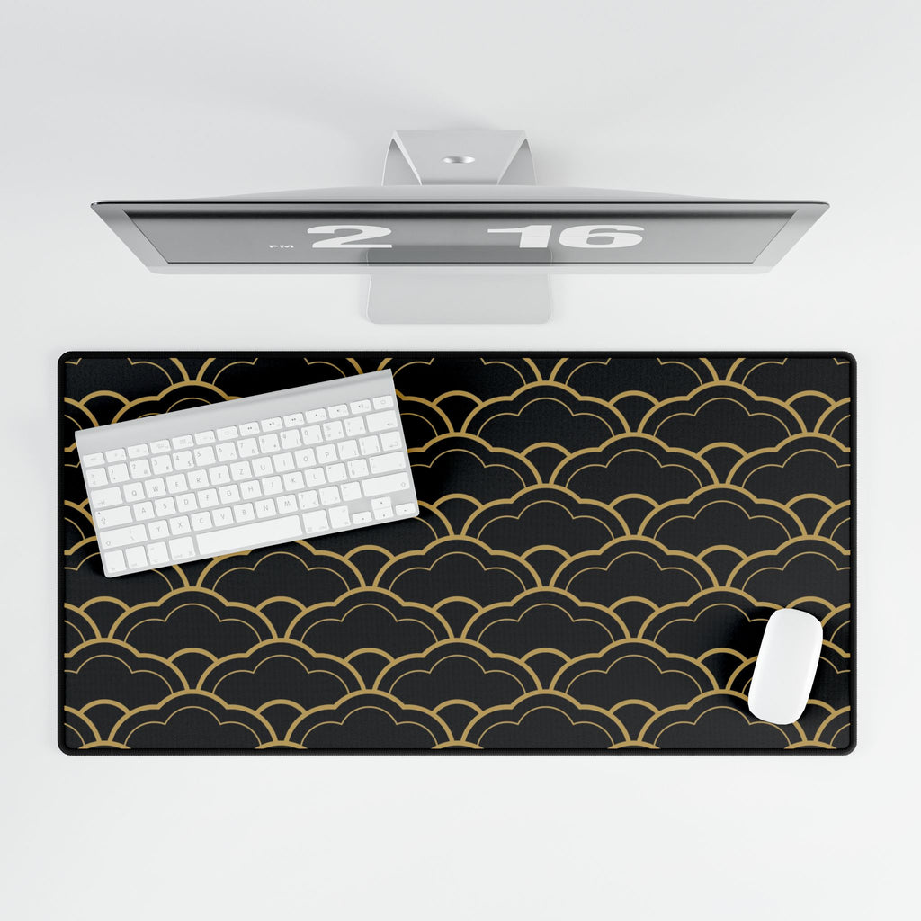Black desk mat with gold wave pattern, white keyboard, and mouse on a white background