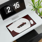 Desk setup with a desk mat featuring a car design, keyboard, mouse, and digital clock.