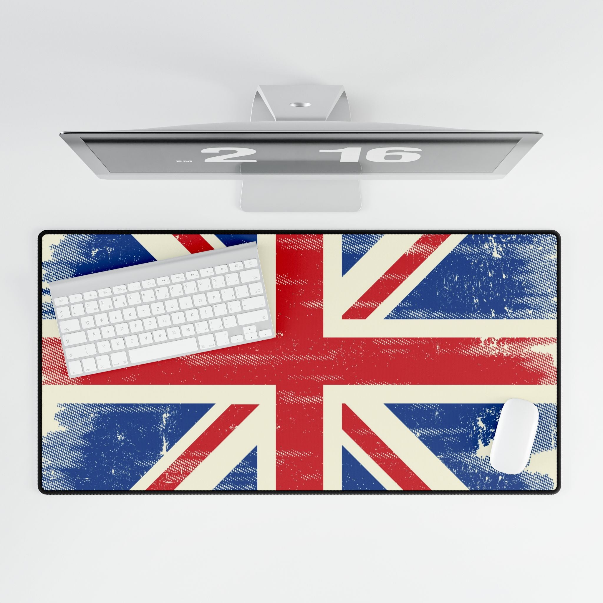 Desk setup with a Union Jack design mouse pad, keyboard, and computer monitor on a white background.