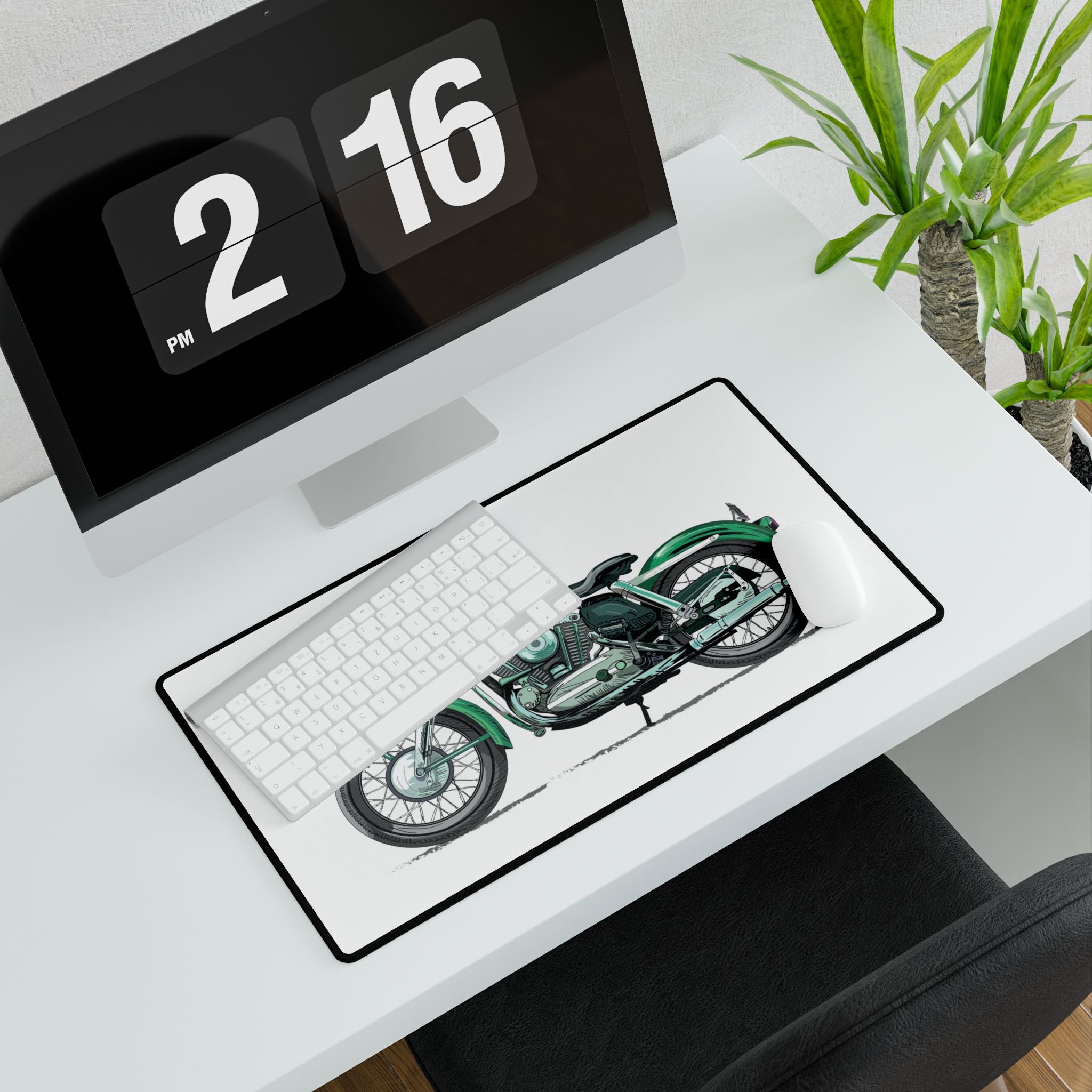 Desk setup with a computer monitor displaying a digital clock, keyboard, and motorcycle design on a mouse pad.