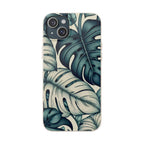 A full, straight-on view of an iPhone in a beige, speckled case with a teal and blue monstera leaf pattern. The case covers the entire back of the phone, and the dual camera lens cutout is visible in the top left corner.