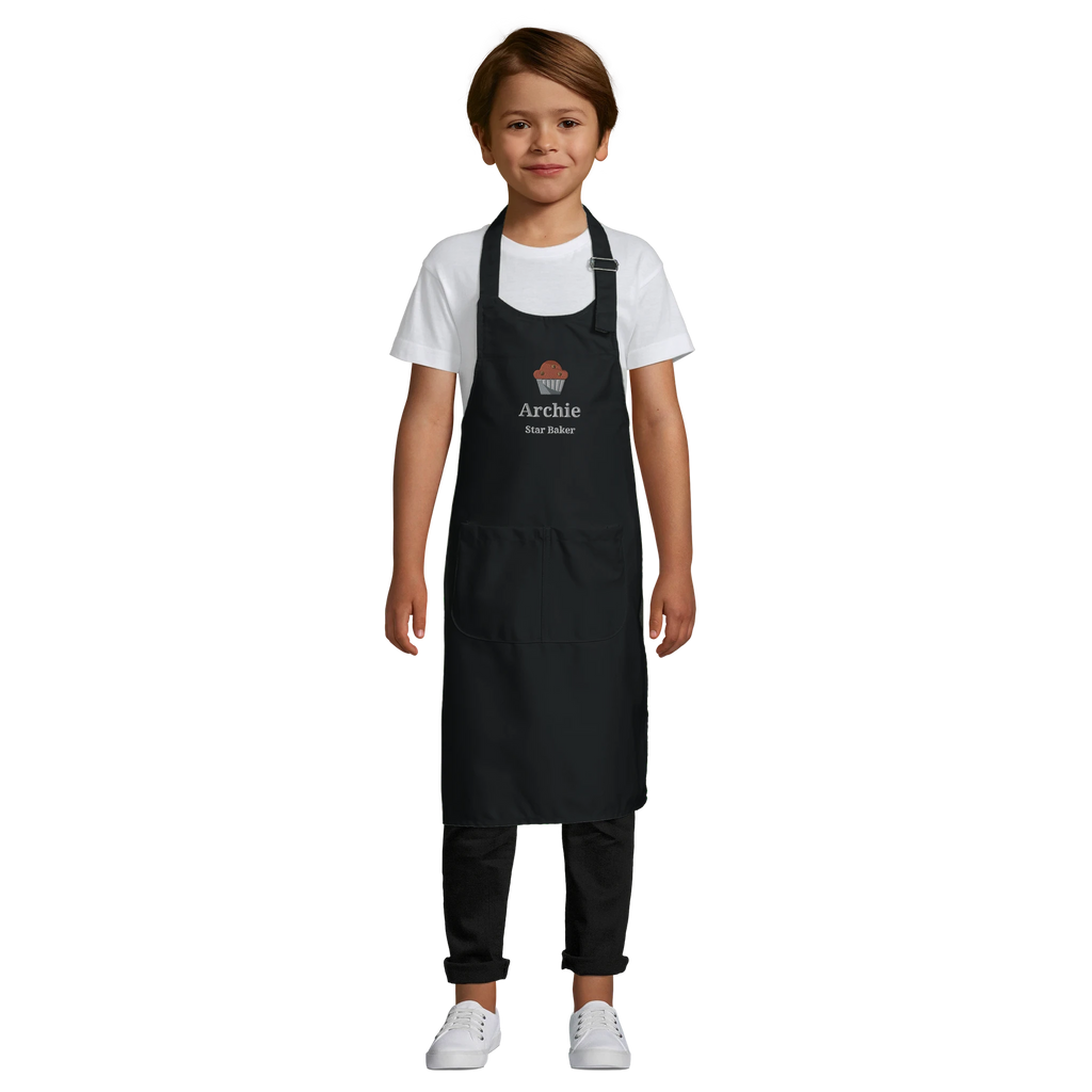Child wearing a black apron with 'Archie' printed on it against a white background