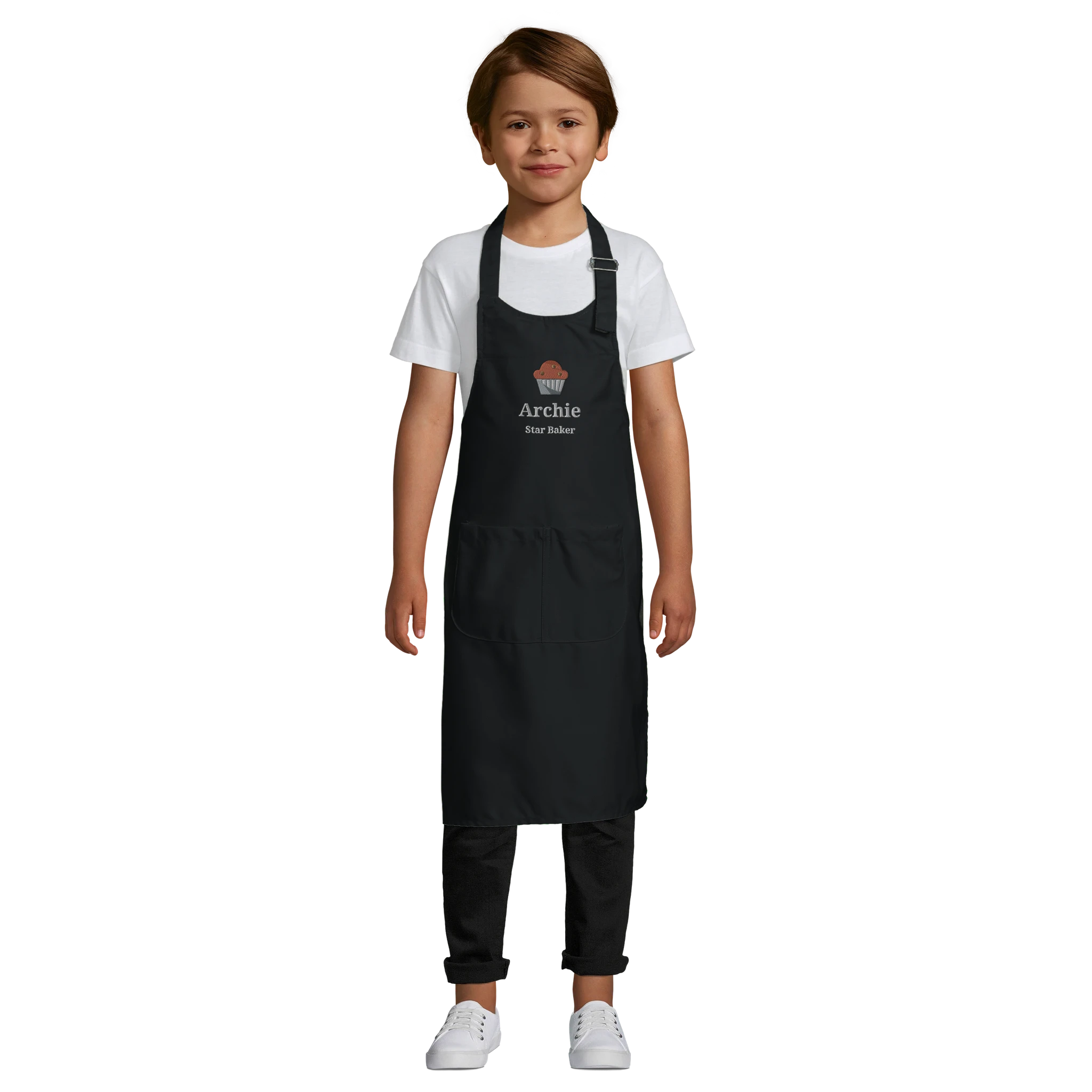 Child wearing a black apron with 'Archie' printed on it against a white background