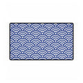 Blue and white wave patterned rug on a white background