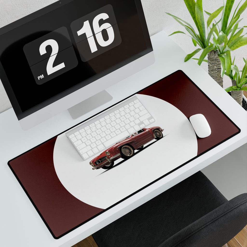 Desk setup with a computer monitor, keyboard, mouse, and large mouse pad featuring a car design.