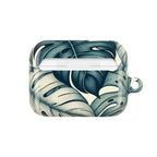 AirPods Pro case with a tropical leaf pattern, featuring large, stylized green and cream monstera leaves. The case is open and empty.
