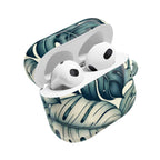 AirPods case with a tropical leaf pattern, featuring large, stylized green and cream monstera leaves. The case is open, revealing the white AirPods inside.