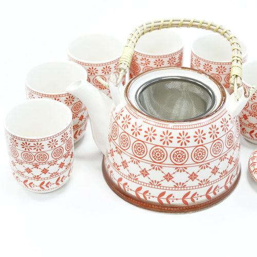 Ceramic tea set with red patterns on a white background