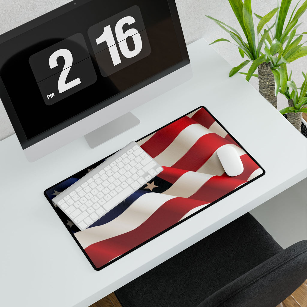 Desk setup with a flag-themed mouse pad, keyboard, and digital clock.