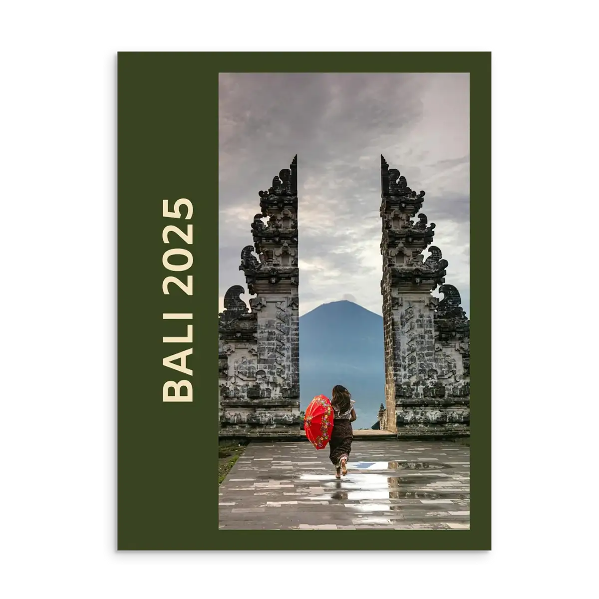 Bali Travel Photo Book with stone gate and person holding a red umbrella, featuring 'Bali 2025' text.
