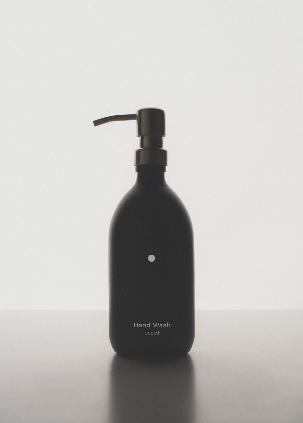 Black hand wash bottle with pump on a white background