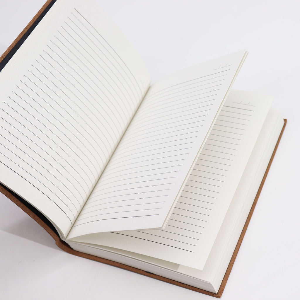 Open notebook with lined pages on a white background from MVB STUDIO official store.