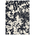 Navy and white floral patterned rug on a plain background