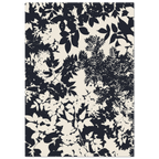 Navy and white floral patterned rug on a plain background
