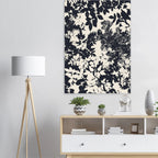 Floral patterned wall art above a wooden console table with decorative items.