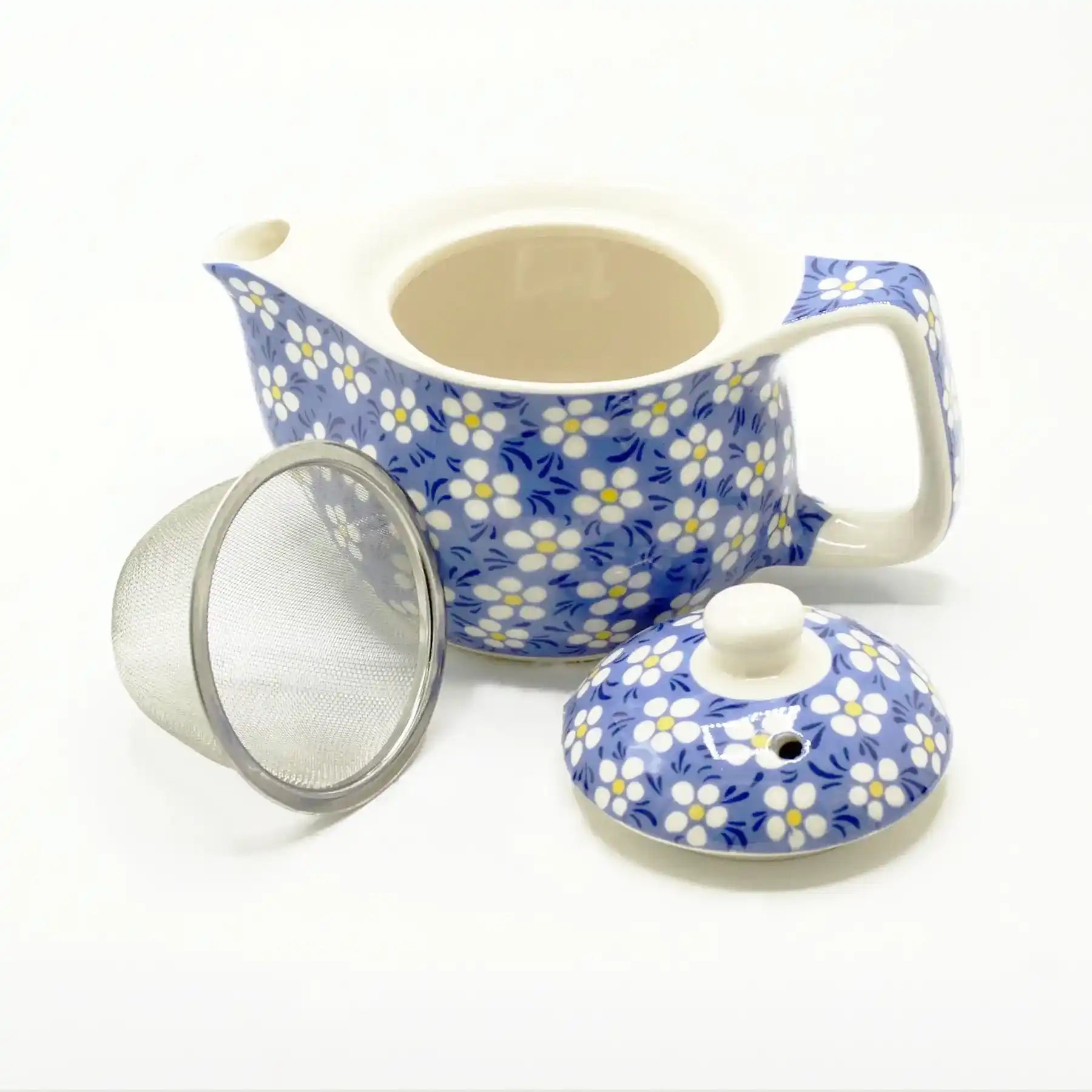 Ceramic teapot with floral pattern, lid, and mesh filter on a white background