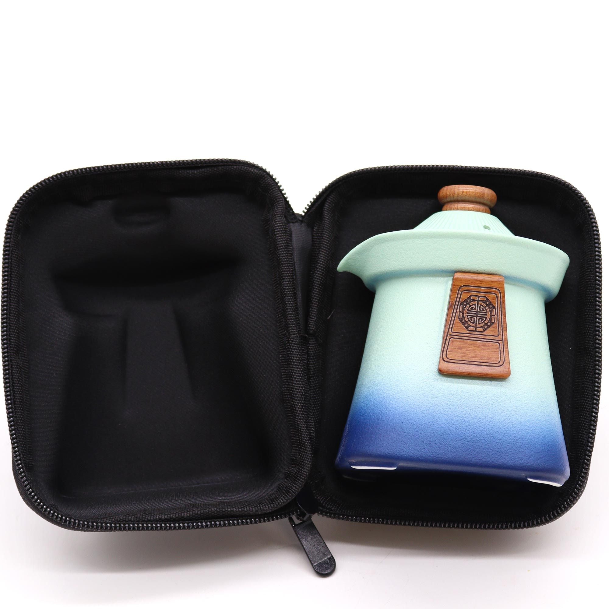 Teal and blue ceramic container with wooden lid in a black case on a white background