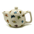 White teapot with colorful butterfly designs on a white background