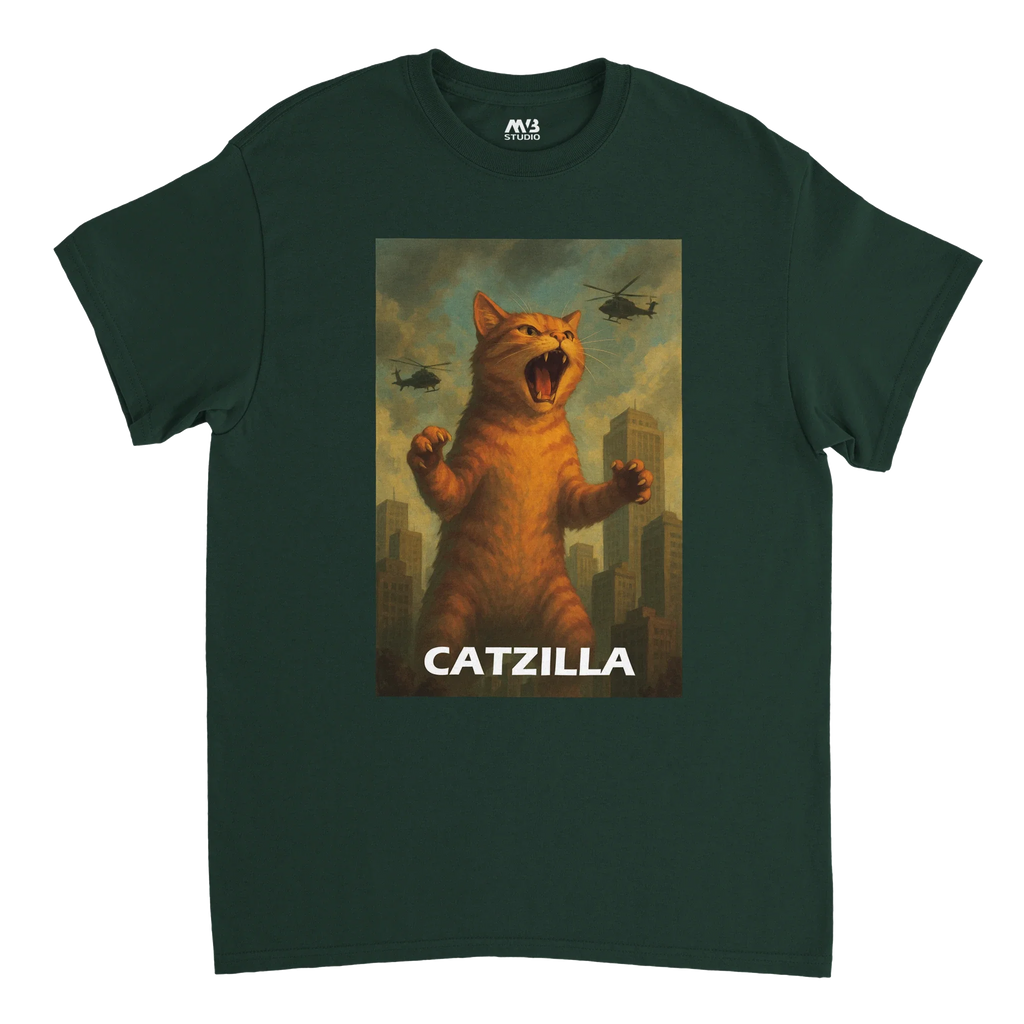 Dark green T-shirt featuring a stylised illustration of a giant roaring cat towering over a city, with helicopters flying overhead and the word “Catzilla”.