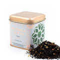 Tea canister labelled 'Mandala Leaves' with Chai Black Tea spilling out on a white background