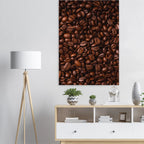 Poster of coffee beans on a wall above a white cabinet with decorative items.