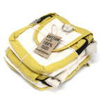 Yellow and white fabric bundle with a 'Cotton' tag on a white background