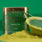 Mandala Leaves Matcha Tea can with green tea powder and a mesh spoon on a green background