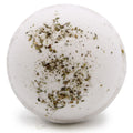 White bath bomb with green and brown specks on a white background