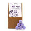 Purple bath bombs with a brown packaging labeled 'Chill Pills' on a white background