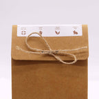 Brown paper package with string bow and a label on a white background