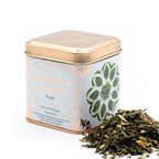 Tea tin labeled 'Mandala Leaves' with Ginger & Lemon Green Tea Sencha Blend 50g spilling out on a white background