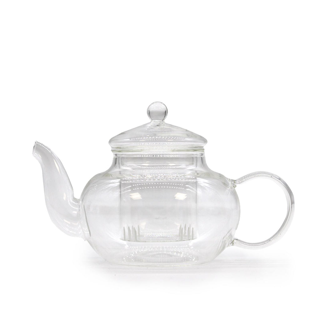 Clear glass teapot with a silver lid on a white background