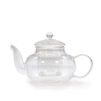 Clear glass teapot with a silver lid on a white background