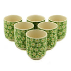 Set of six ceramic cups with floral pattern on a white background