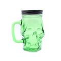 Green skull-shaped jar with a black lid on a white background