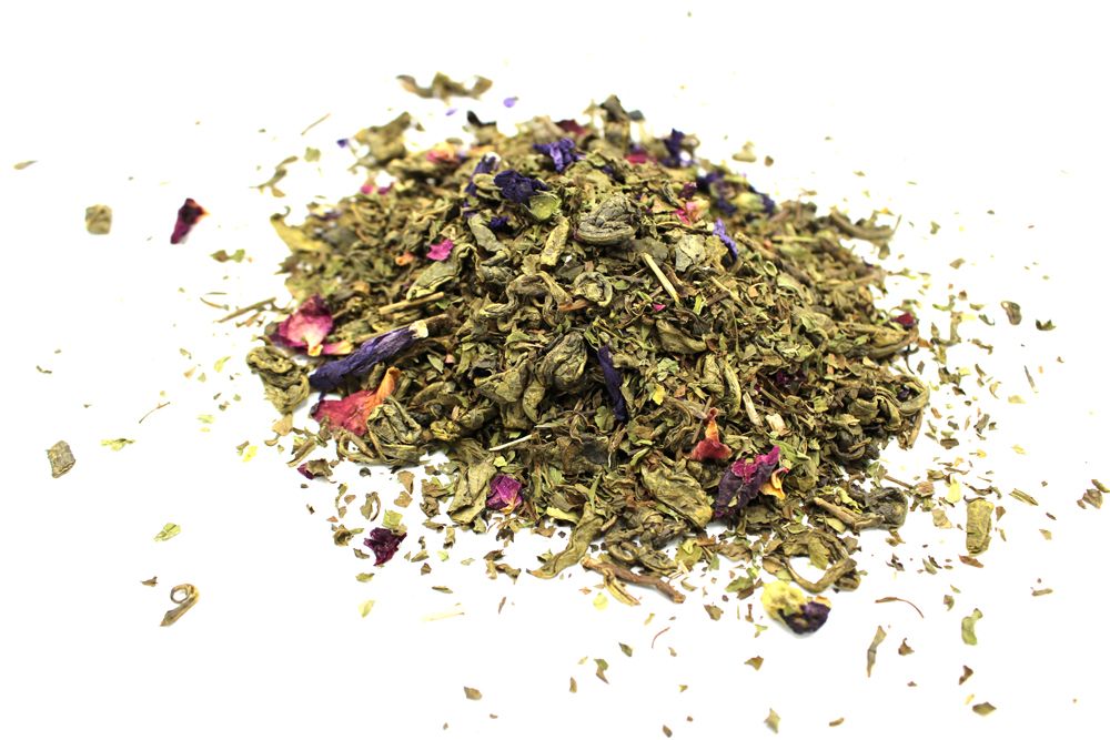 Green Tea Marrakech Petals with Mint - 1Kg, heap of green tea leaves with dried flowers on a white background
