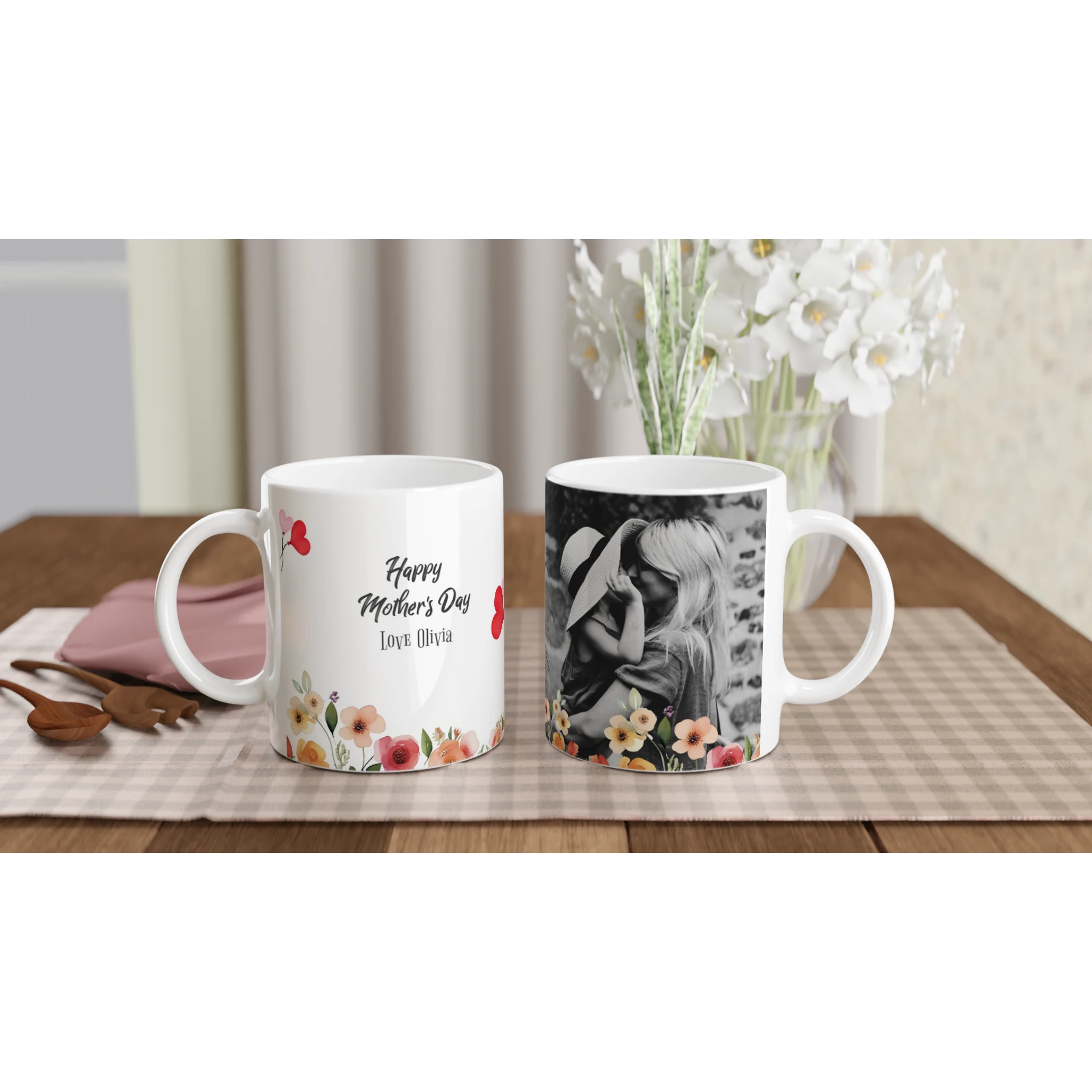 Two mugs on a table with one featuring a floral design and the other with a photo of a woman, placed against a neutral background.