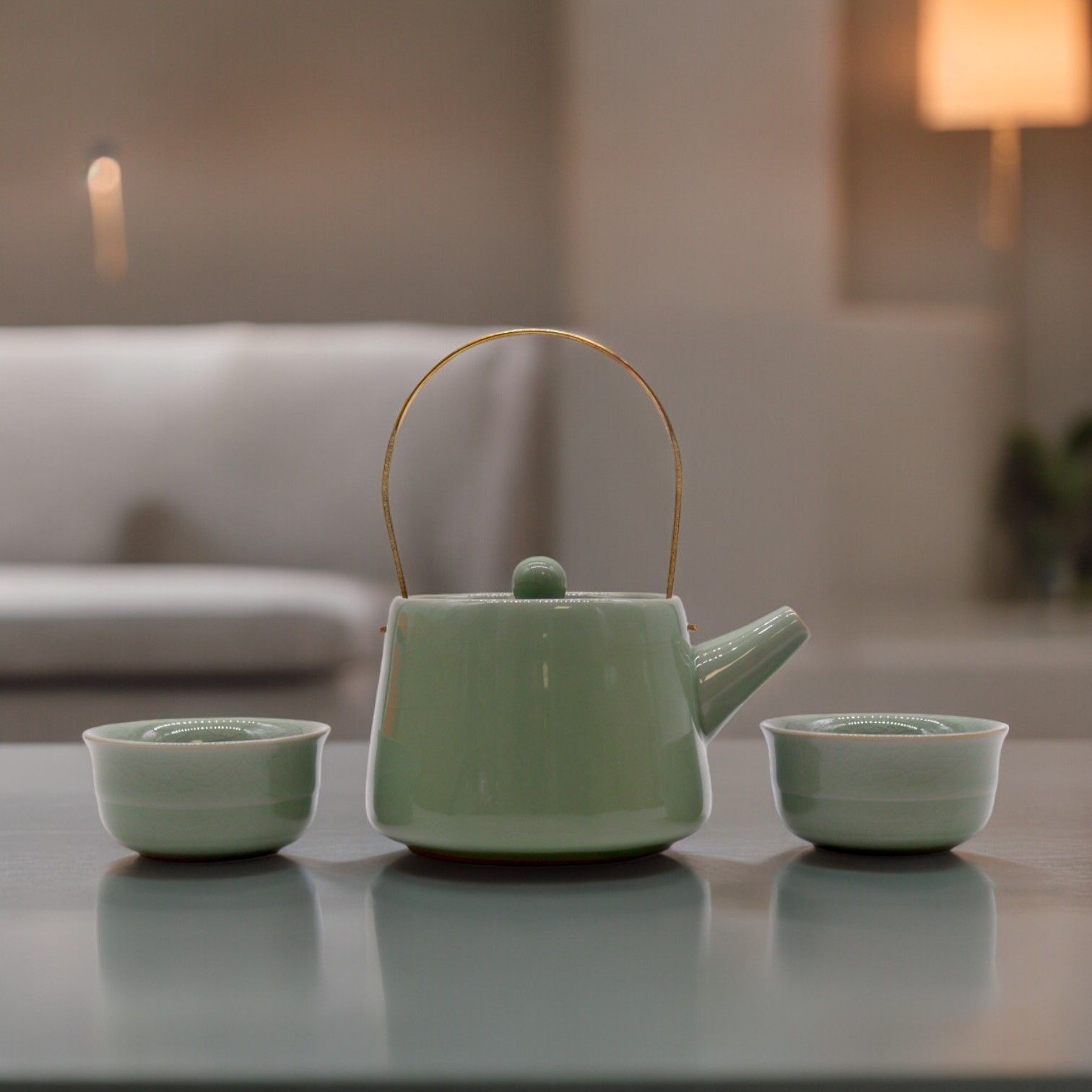 Green ceramic teapot with two matching cups on a reflective surface from MVB STUDIO official store.