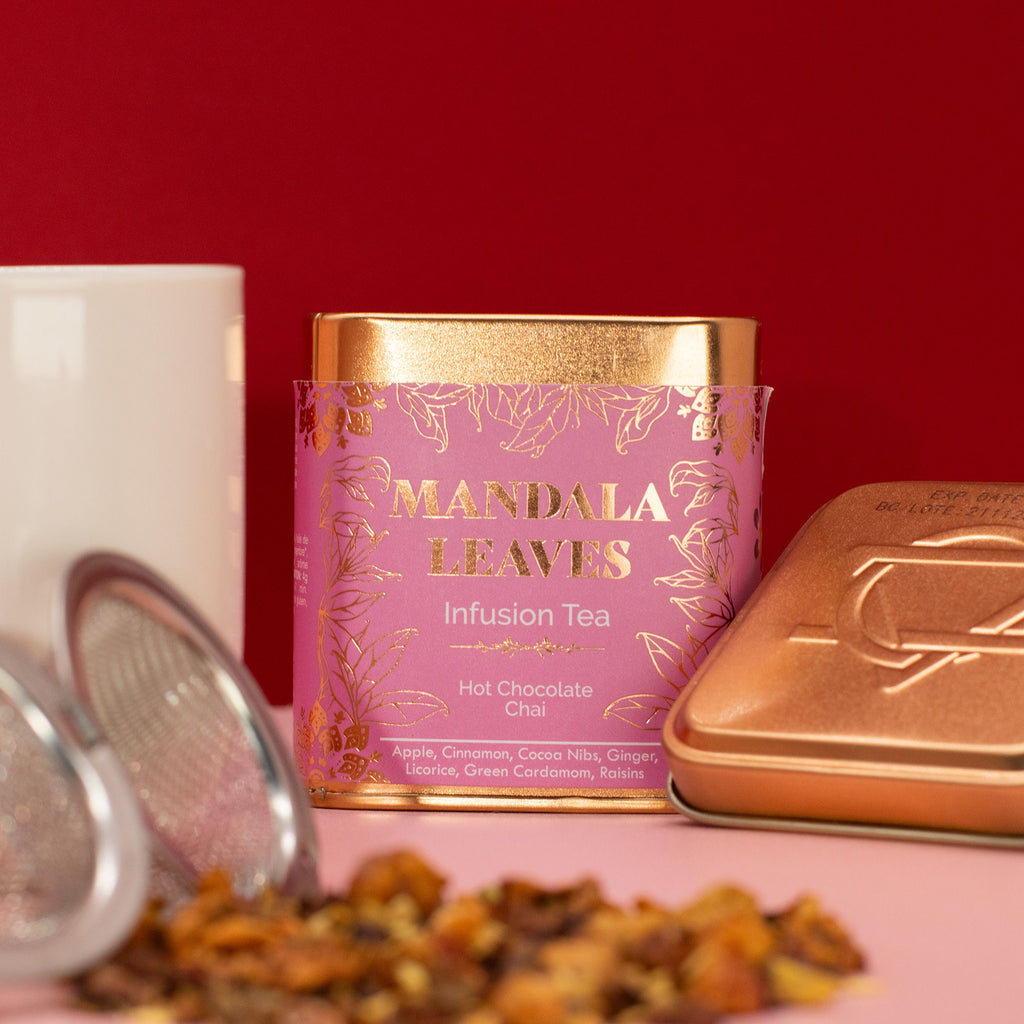 Hot Chocolate Chai Infusion - 50g, Mandala Leaves tea canister with tea leaves and a white mug on a red background