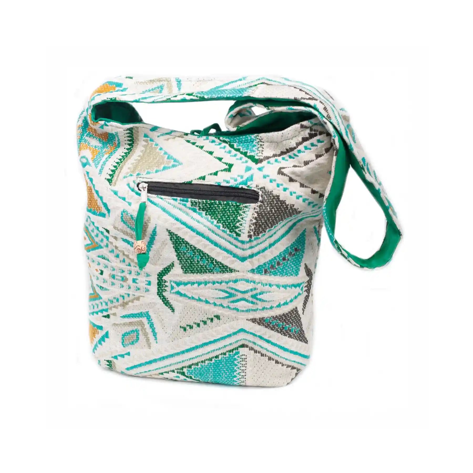 Patterned shoulder bag with a green strap on a white background