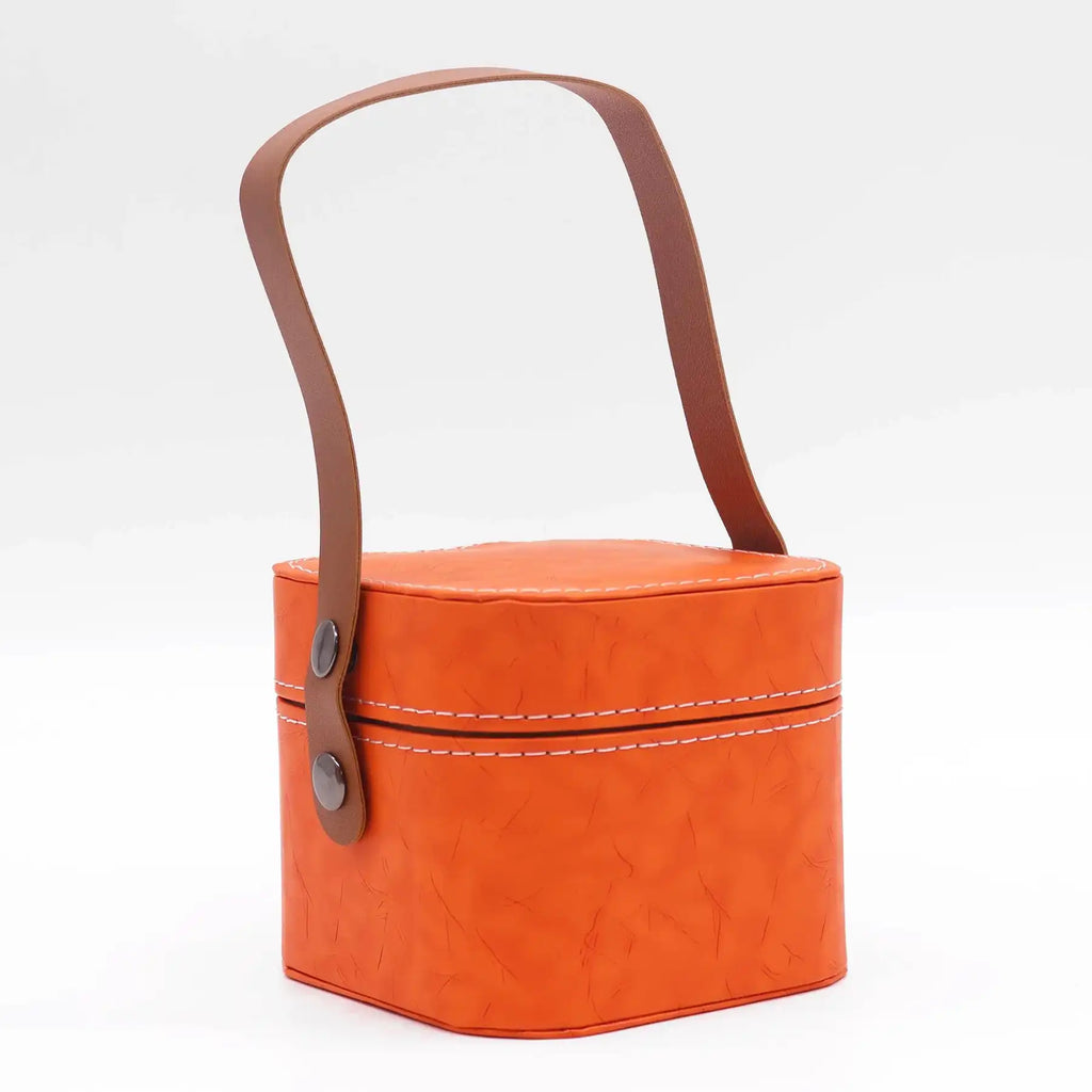 Orange basket with a brown handle on a white background