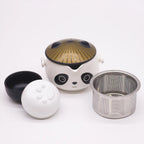 Panda-shaped tea set with black lid, white base, and metal filter on a white background