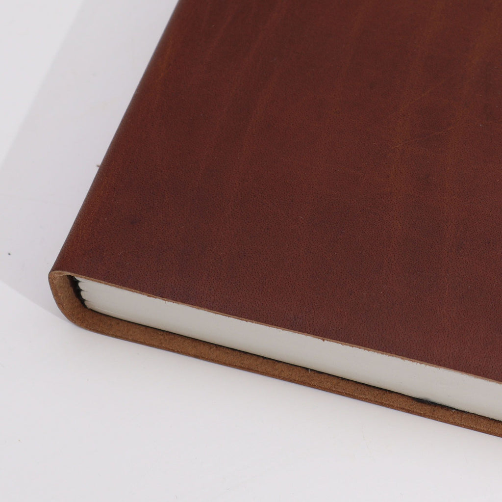 Close-up of a brown leather-bound book on a white background from MVB STUDIO official store.