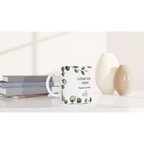 Mug with 'Love You Mum' text on a white surface with books and decorative items.